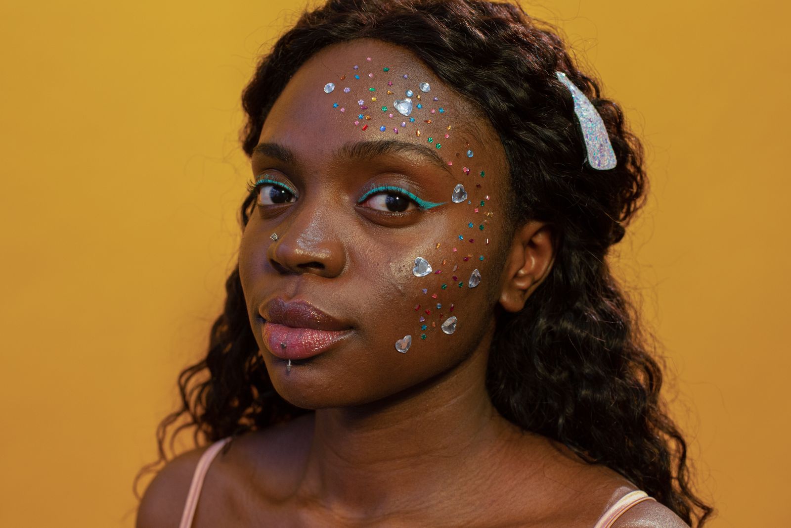 A woman looking at the camera, for a Pulse Report on whimsymaxxing and the bedazzling revival
